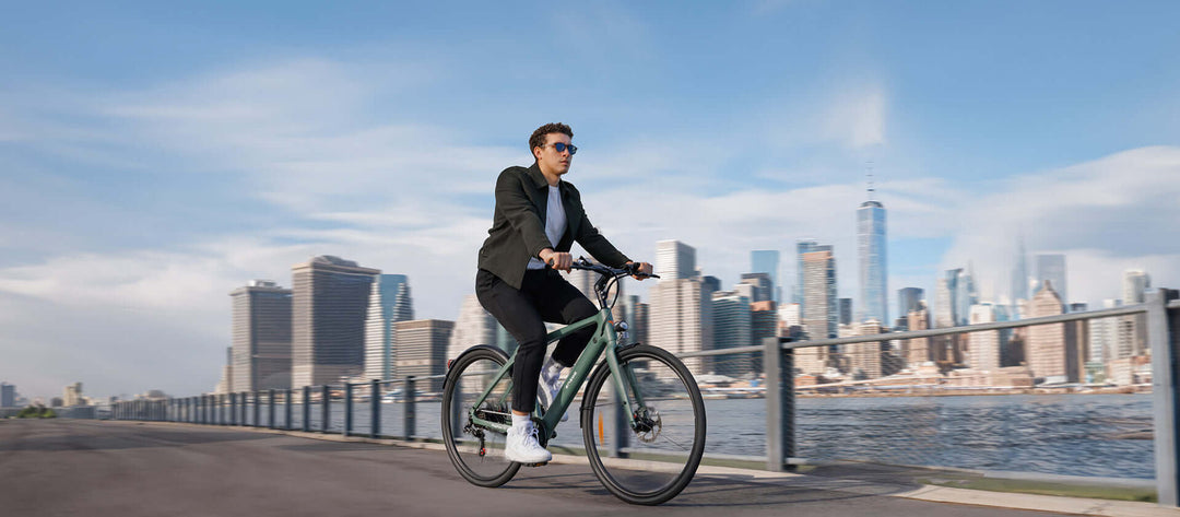 ENGWE MAPFOUR N1 review - commuter riding a lightweight bike with a city skyline backdrop.