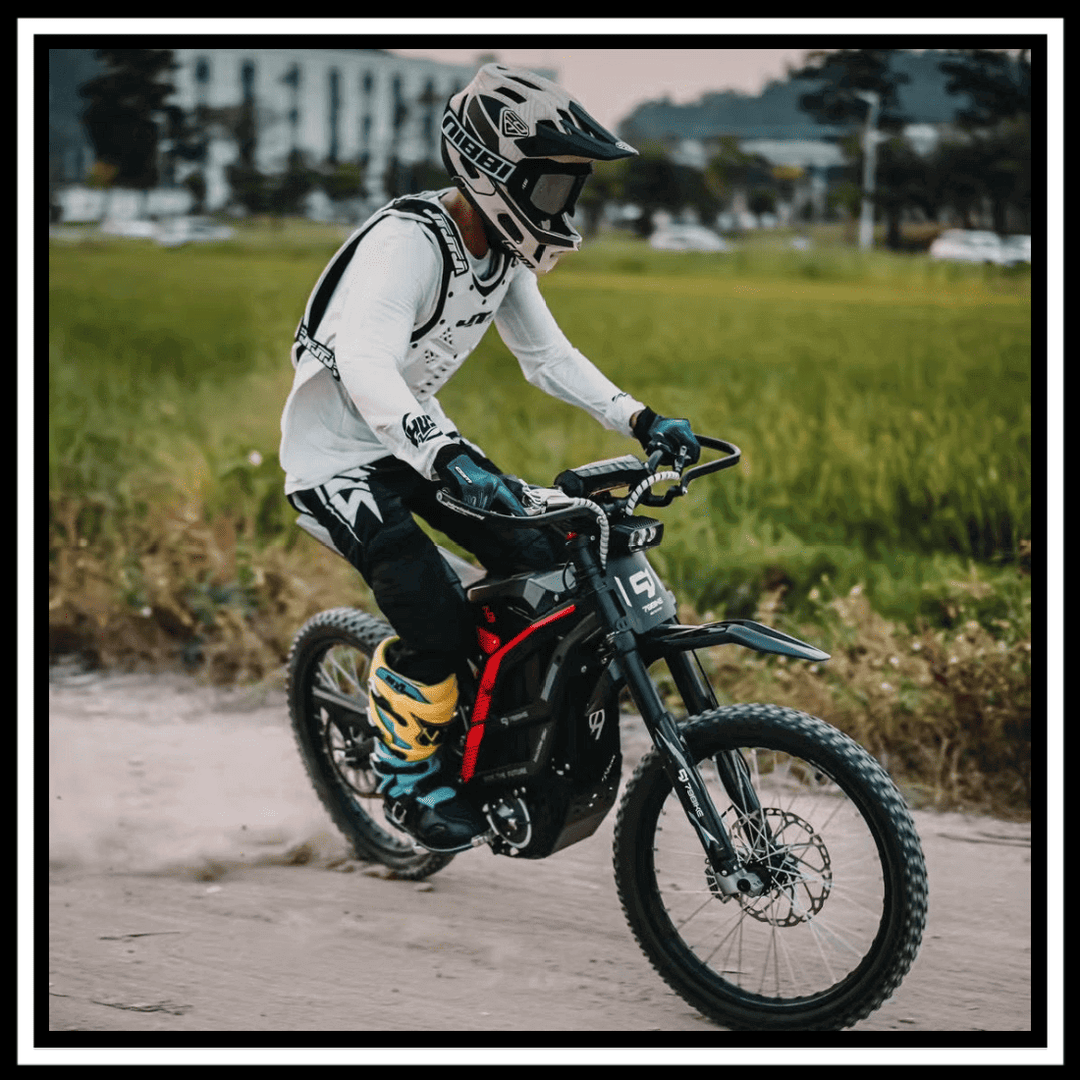 Rider on a 🇮🇪🇪🇺🇬🇧🇺🇸 79BIKE-FALCON PRO 10000W OFF-ROAD electric dirt bike on a dirt trail.