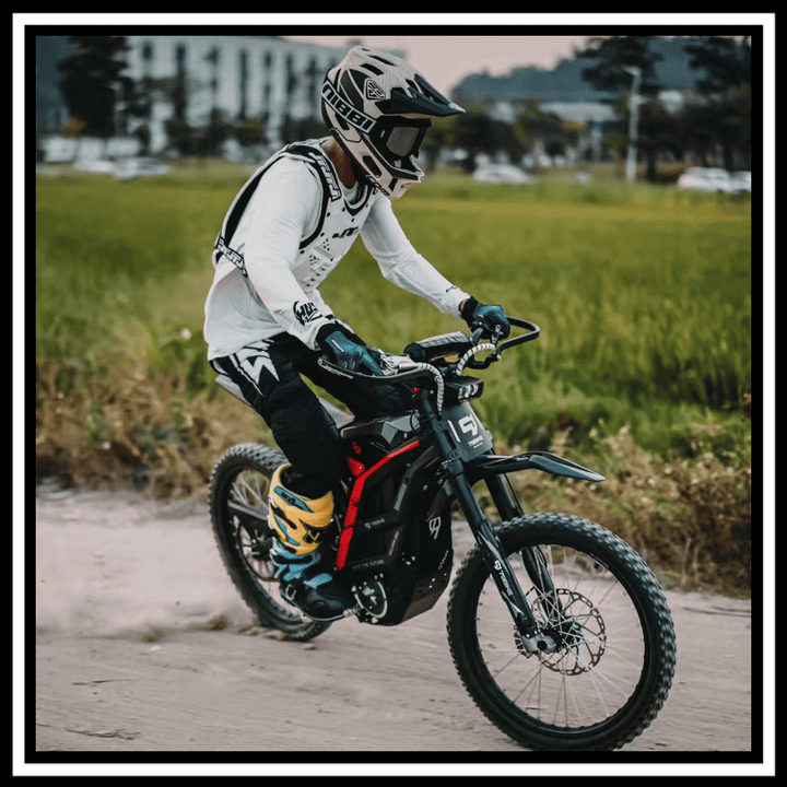 Rider on a 🇮🇪🇪🇺🇬🇧🇺🇸 79BIKE-FALCON PRO 10000W OFF-ROAD electric dirt bike on a dirt trail.
