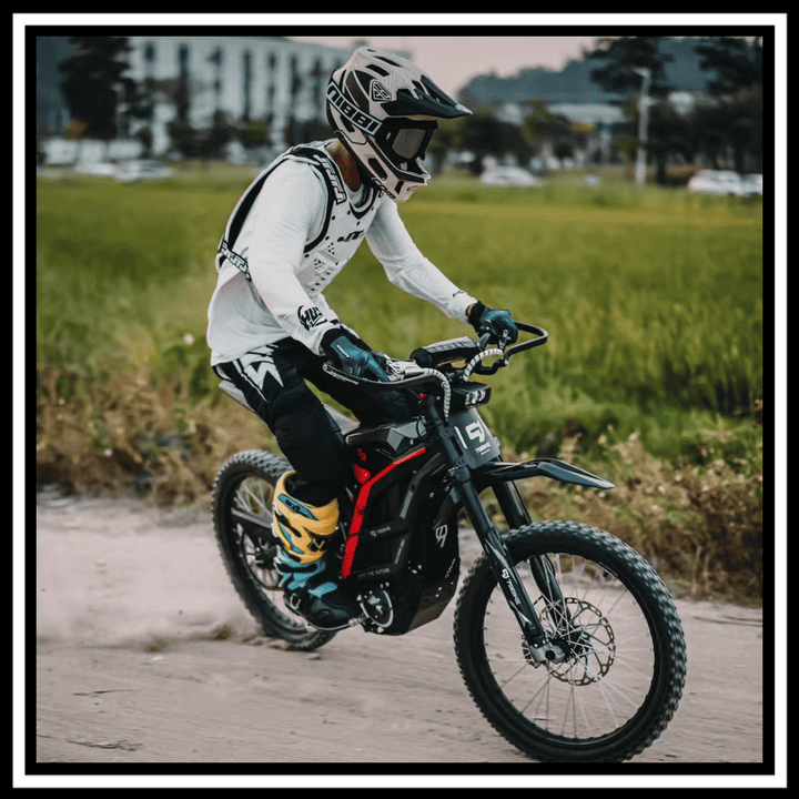Rider on a 79BIKE-FALCON PRO ELECTRIC DIRT BIKE navigating through grassy terrain.