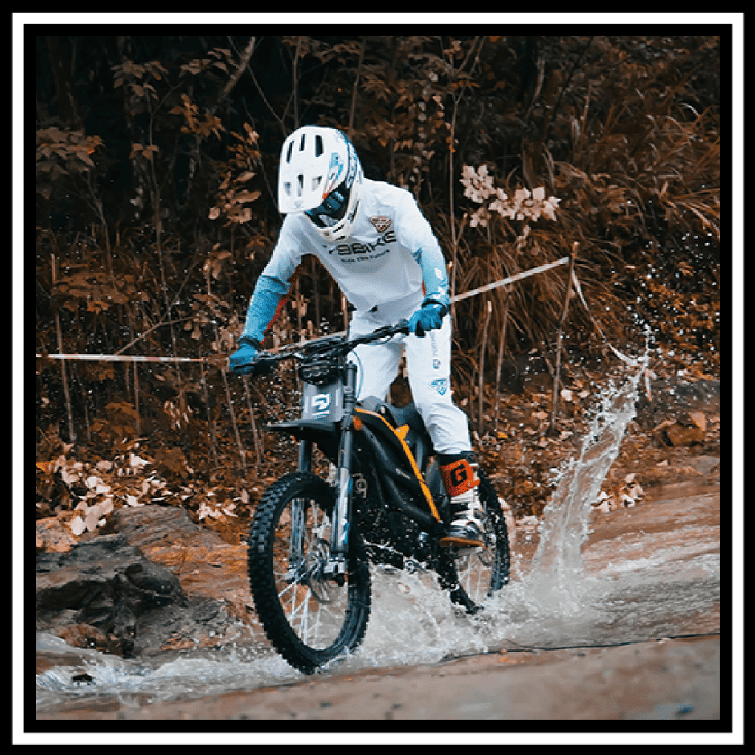 79BIKE-FALCON PRO ELECTRIC DIRT BIKE riding through water with splashes, showcasing performance and adventure