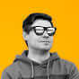 Confident person wearing sunglasses against a vibrant yellow background, showcasing modern style.