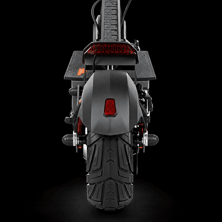 Kukirin G4 Ultra Electric Scooter - Rear view of a black electric scooter with a matte black body, textured rear tire, and red taillight on a solid black background.