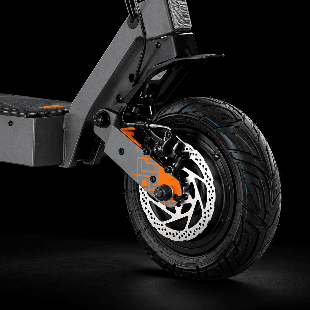 Kukirin G4 Ultra Electric Scooter - Close-up of a black electric scooter wheel with a silver disc brake, black tire, and bright orange front fork accent against a dark studio background.