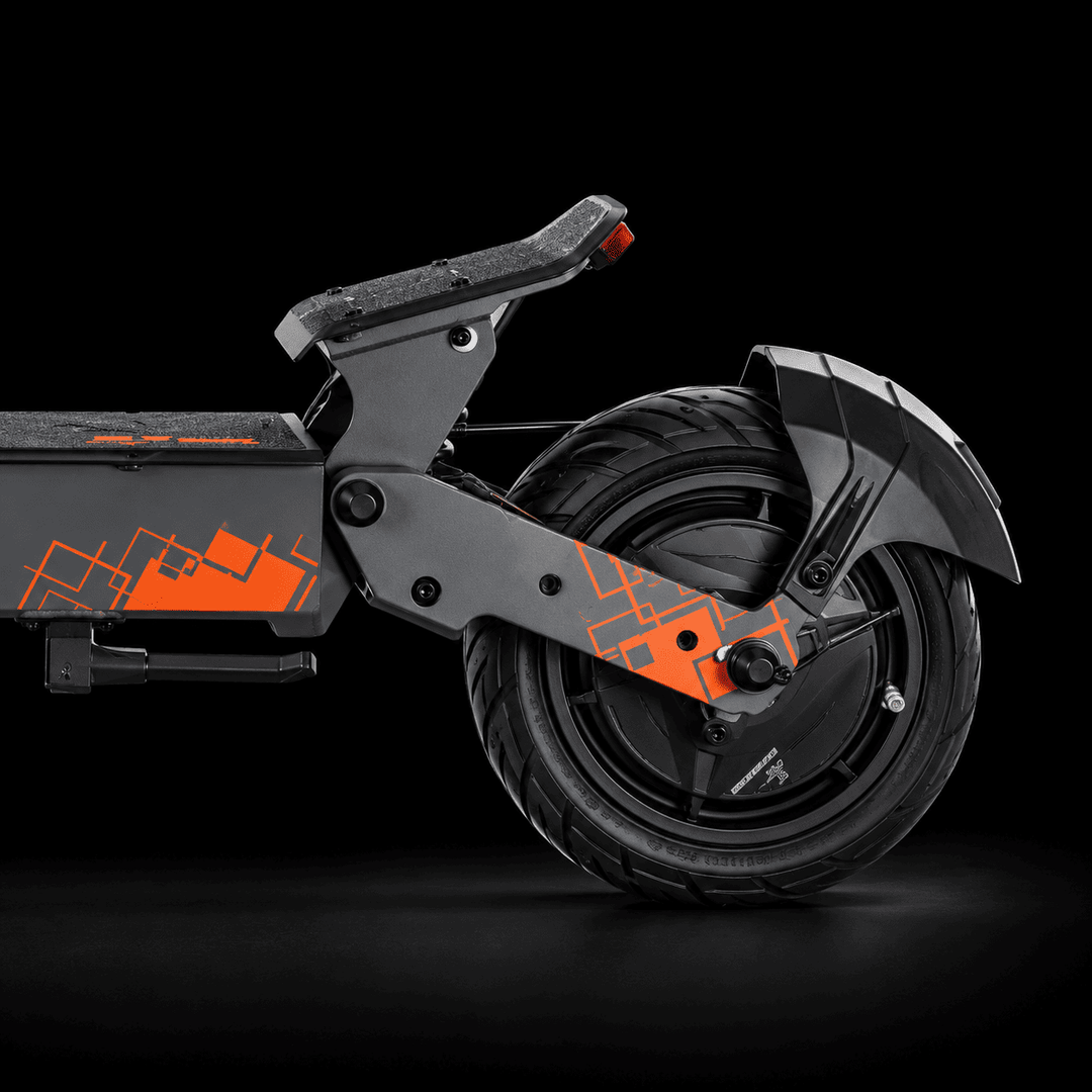 Close-up side view of a black electric scooter with bright orange geometric graphics and a black seat, photographed against a dark studio background. Kukirin G4 Ultra Electric Scooter 
