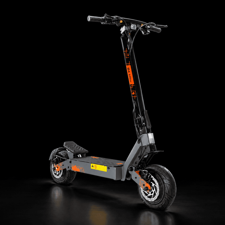 A modern Kukirin G4 Ultra Electric Scooterwith a dark gray frame and black wheels, accented with bright orange graphics and a yellow warning label, photographed on a reflective black studio background.