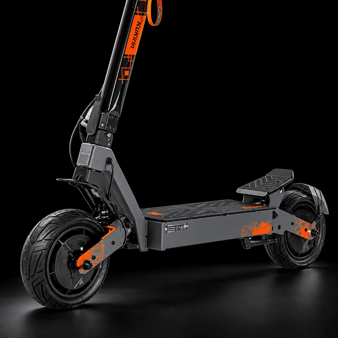 A modern Kukirin G4 Ultra Electric Scooter with a dark gray and black frame, accented with bright orange graphics and branding, shown against a solid black studio background.