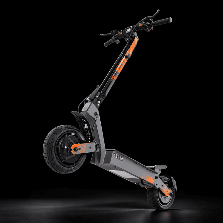 A modern Kukirin G4 Ultra Electric Scooter with a dark gray and black frame accented by bright orange details, shown in a dynamic three-quarter view against a solid black studio background.