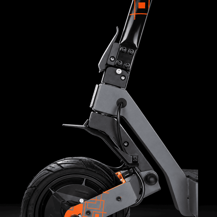 Kukirin G4 Ultra Electric Scooter - Close-up of a black and gray electric scooter showing the front wheel, suspension fork, and handlebar joint with orange accent details, set against a solid black background.