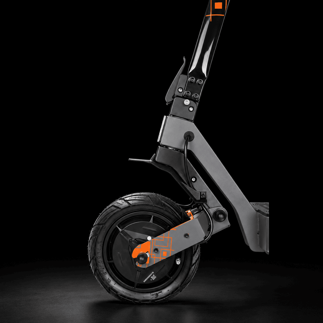 Kukirin G4 Ultra Electric Scooter - Close-up studio shot of a folding electric scooter frame and front wheel against a black background, with orange accent details on the fork and handlebar.