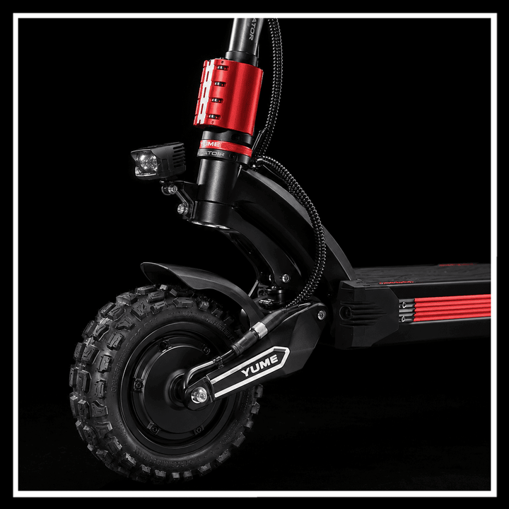 Close-up of YUME Raptor 2 electric scooter showcasing its rugged wheel and front light for high-performance rides.