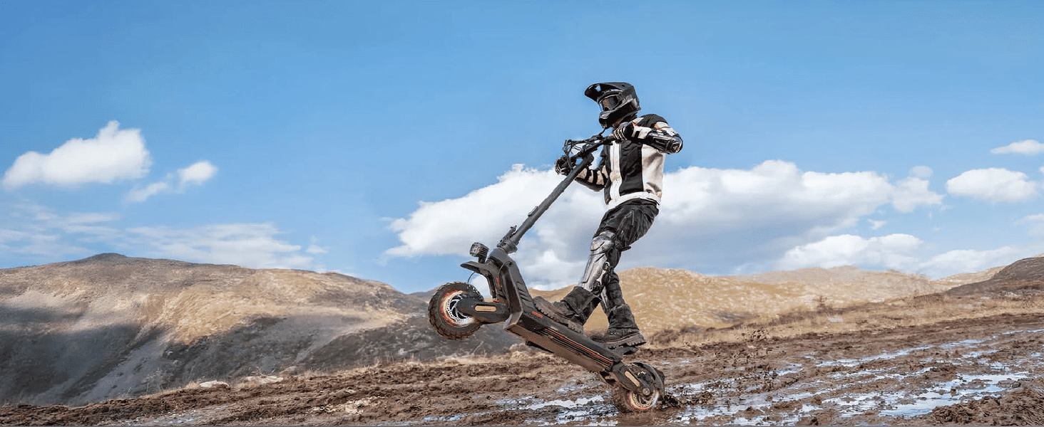 A rider performing a stunt on a powerful electric scooter in a rugged outdoor setting.