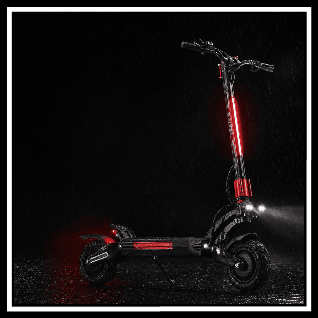 YUME Raptor 2 electric scooter illuminated in the rain with vibrant red lights against a dark background.