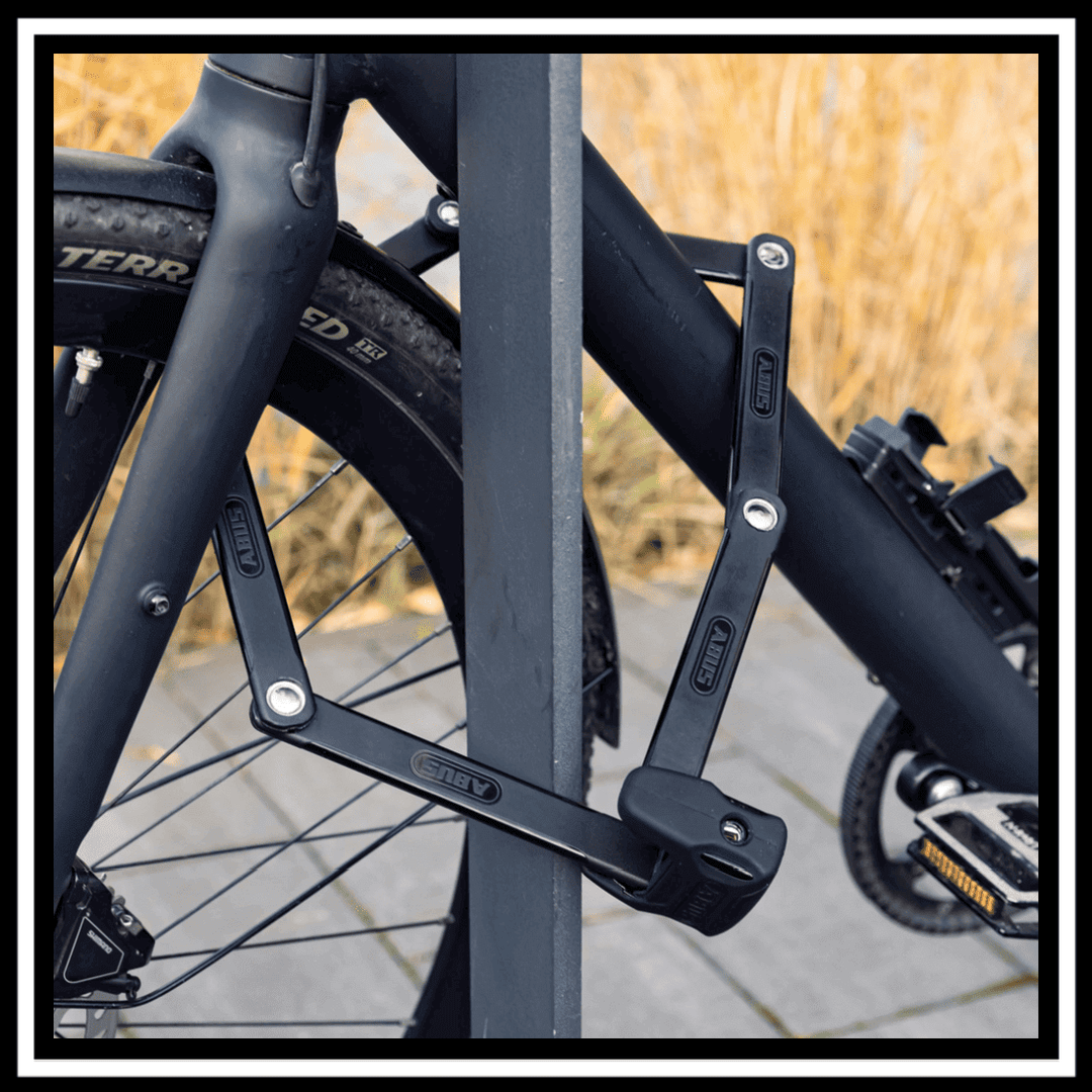 ABUS BORDO BIG 6000K90120 SAFER LOCKER secured to a bike frame at a bike rack.