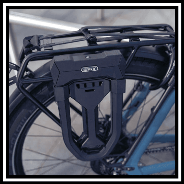 ABUS GRANIT SUPER EXTREME 2500 U-lock mounted on a bicycle's rear rack for maximum security.