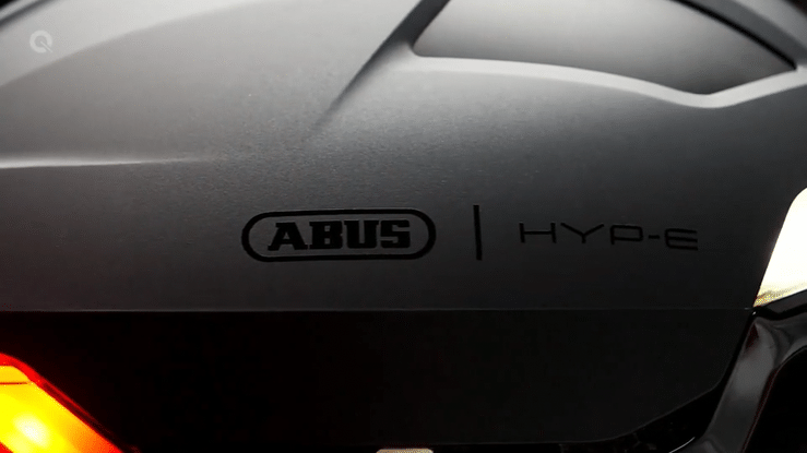 Close-up of ABUS HYP-E ACE BICYCLE HELMET ELECTRIC BIKE with logo and light feature.