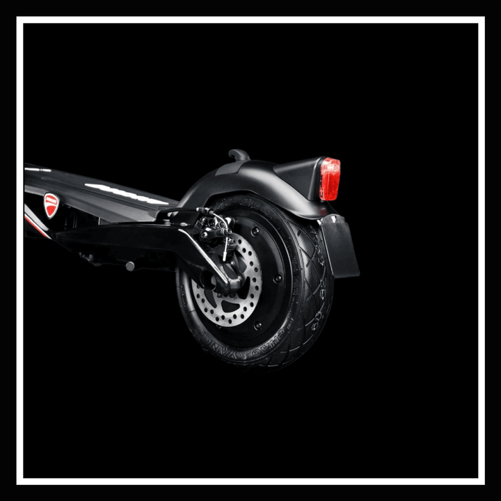 Close-up of the rear wheel and brake of the 🇮🇪 DUCATI PRO III electric scooter showcasing its high-performance design.