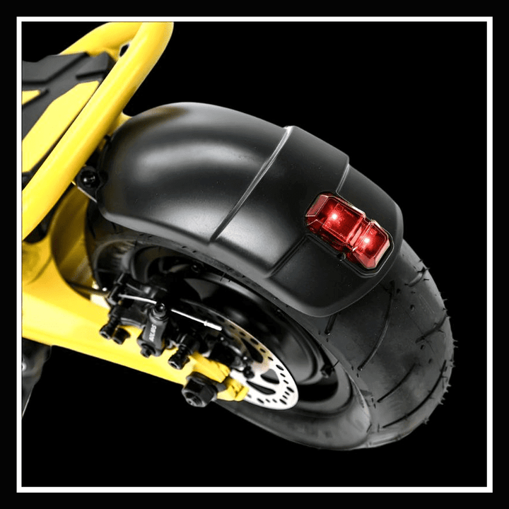 Close-up of the rear wheel and tail light of the 🇮🇪 DUCATI SCRAMBLER E-CROSS electric scooter.