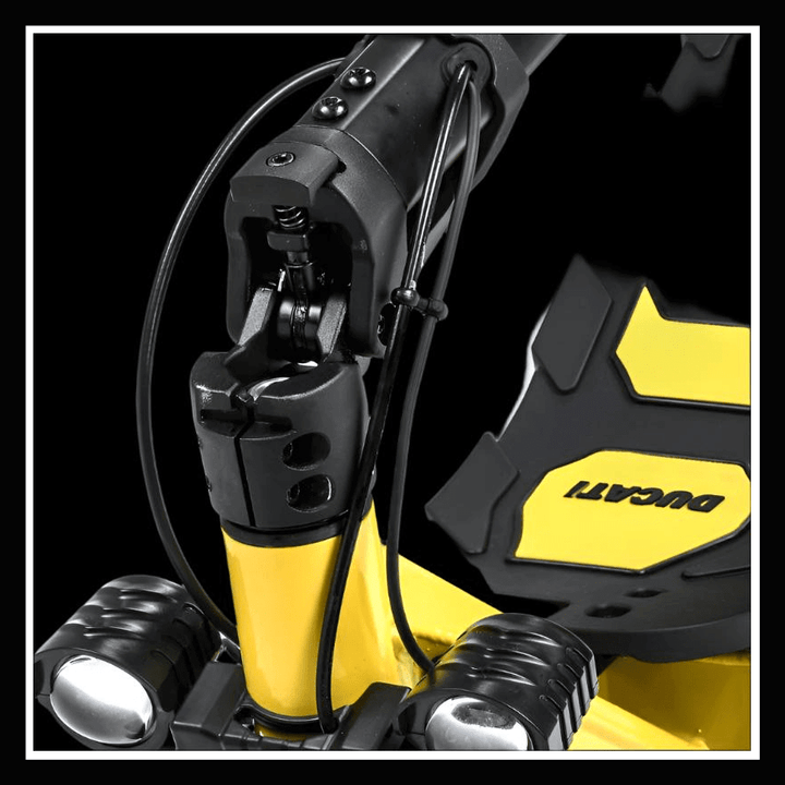 Close-up of the yellow DUCATI SCRAMBLER E-CROSS scooter showcasing the folding mechanism and branding.