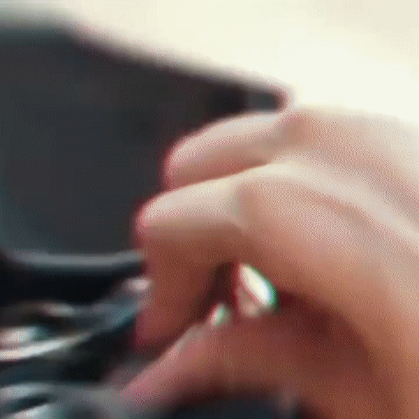 Close-up of a hand adjusting controls on the EAHORA M8S electric motorcycle, highlighting user interaction.