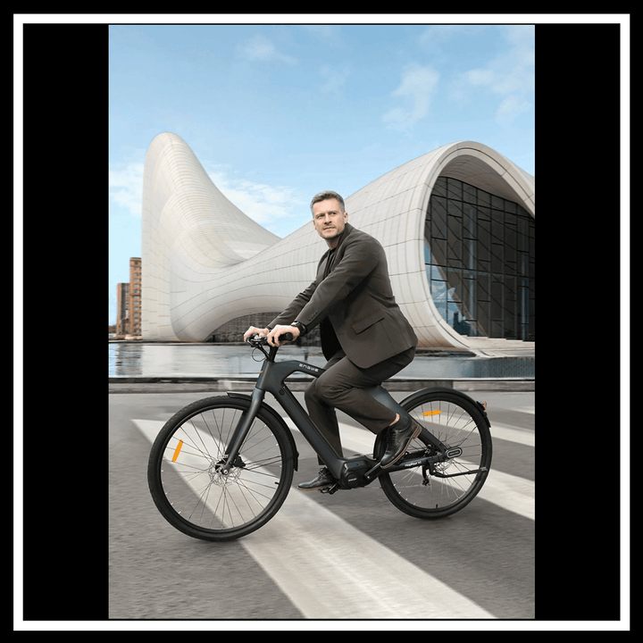Man in a suit riding the 🇮🇪🇬🇧🇪🇺 ENGWE MAPFOUR N1 PRO e-bike in an urban setting.