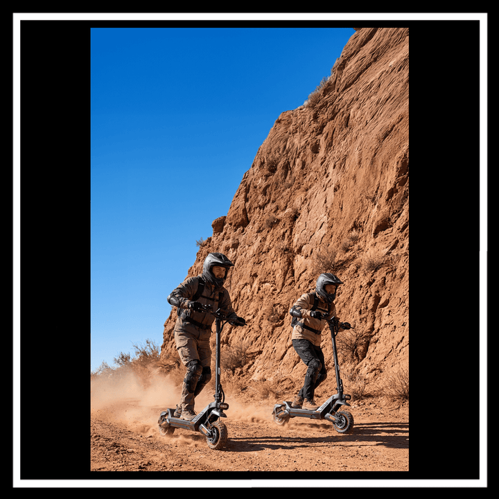 Two riders on ENGWE Y1000 Electric Scooters navigating an off-road trail against a rocky backdrop.