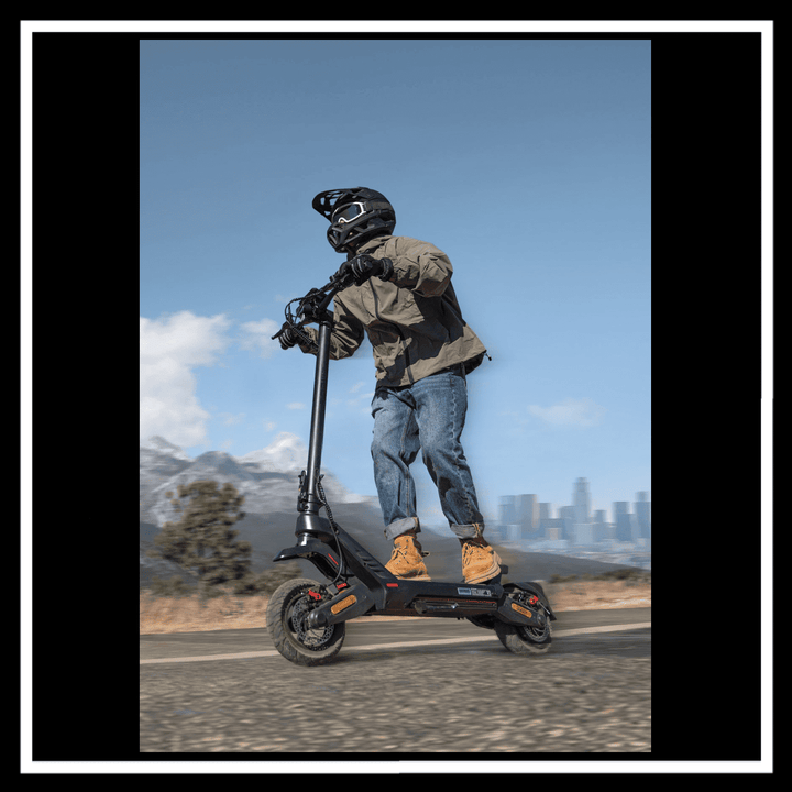 Person riding ENGWE Y700 Electric Scooter on a scenic road with city skyline in background.