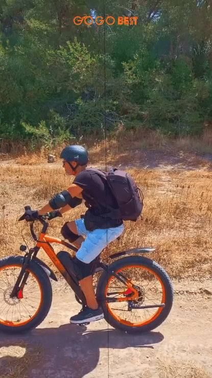 Person riding the GOGOBEST GF600 PLUS 1000W ELECTRIC BIKE on a dirt trail surrounded by nature.