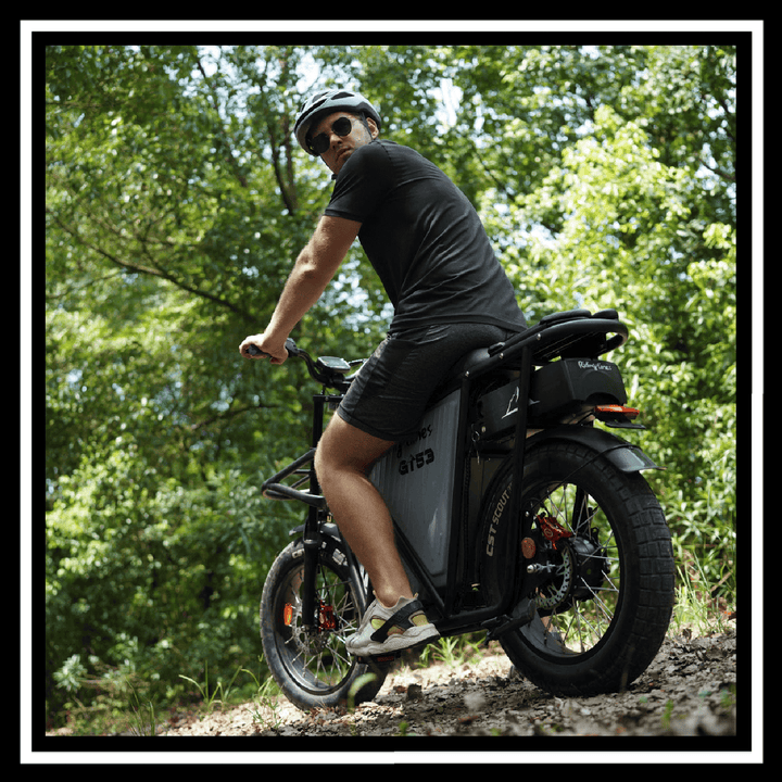 Man riding the 🇮🇪🇪🇺🇺🇸 GT53 2000W CARGO RIDING' TIMES E-BIKE on a forest path.