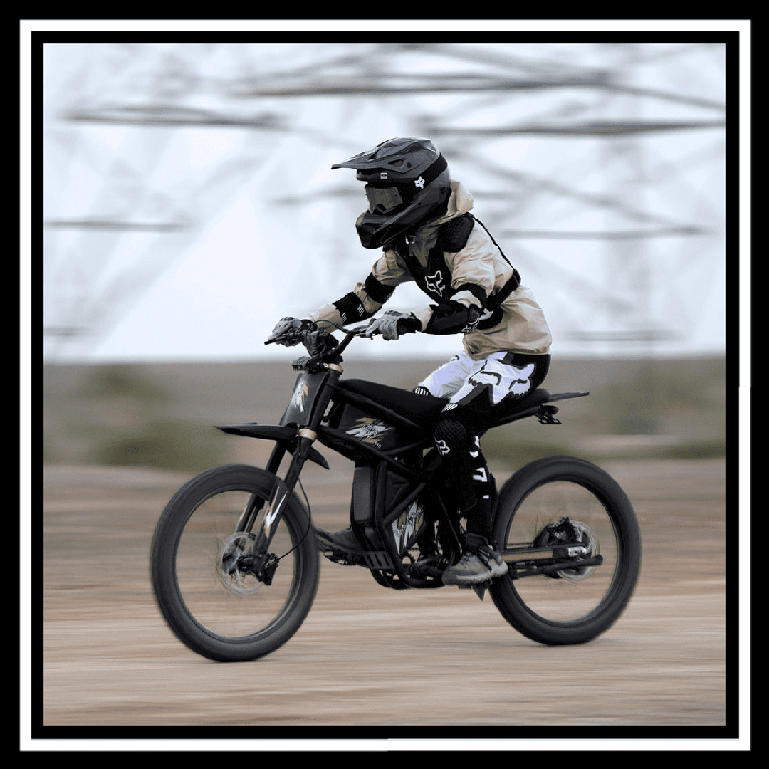 Rider performing on the GT73 2400W RIDING' TIMES DIRT E-BIKE in an off-road setting.