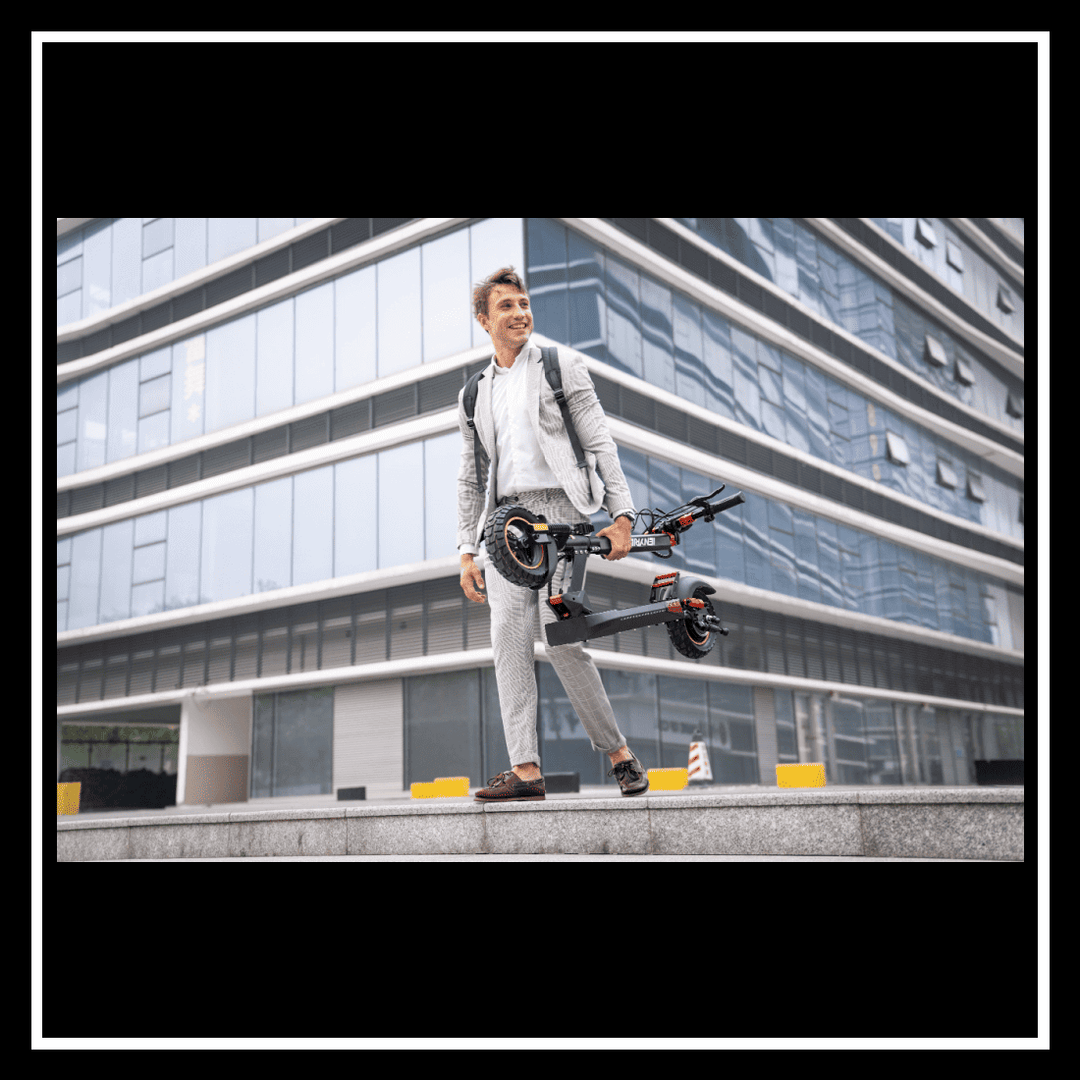 A man in a business suit carrying the 🇮🇪🇪🇺🇬🇧🇺🇸 iENYRID M4 PRO S+ electric scooter outside a modern building.