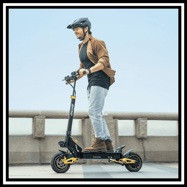 Man riding the 🇮🇪🇪🇺🇬🇧🇺🇸 iENYRID ES1 Electric Scooter on a city sidewalk.