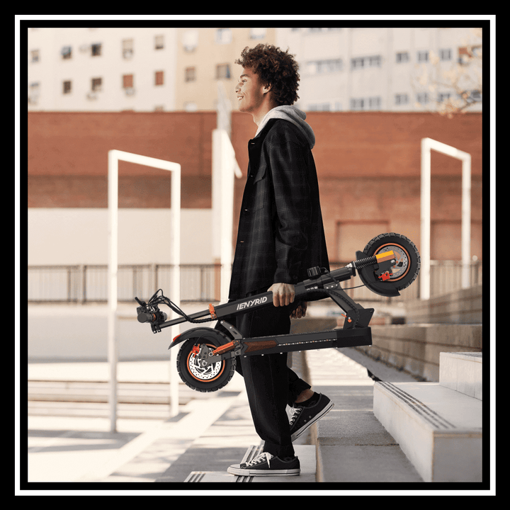 Young person carrying the iENYRID M4 PRO S+ electric scooter up the stairs.