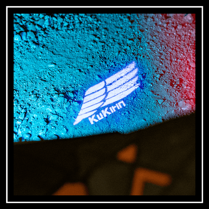 kuKirin logo illuminated on ground with blue and red lighting, showcasing the kuKirin electric scooter t3 branding.