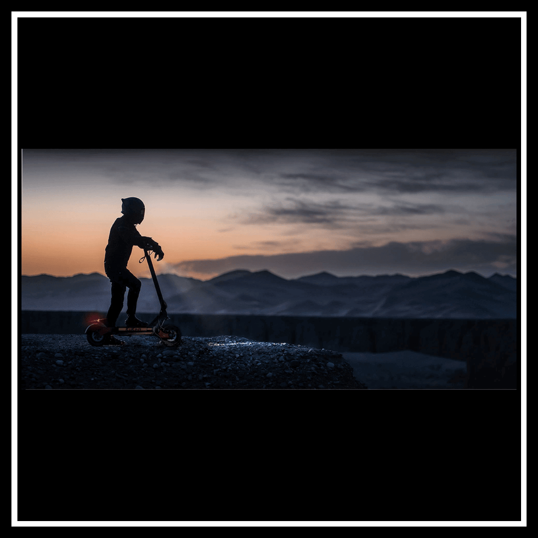 KUKIRIN G3 electric scooter at sunset with mountains in the background, showcasing its sleek design.