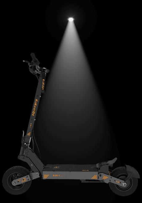 Kukirin G4 electric scooter illuminated by spotlight against dark background showcasing its sleek design.