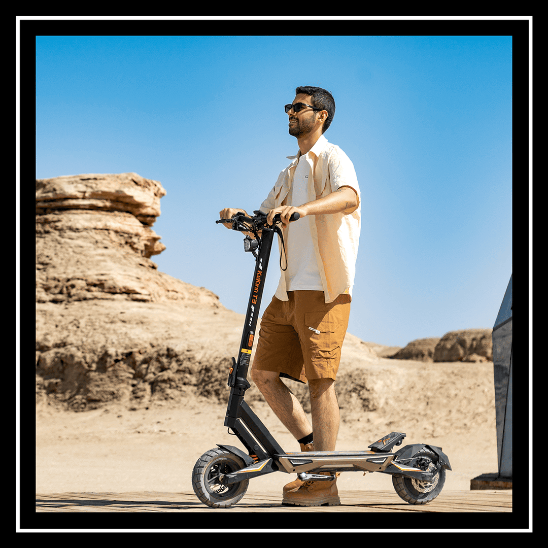 Person riding the 🇮🇪🇪🇺 KUKIRIN T3 ELECTRIC SCOOTER in a desert landscape.