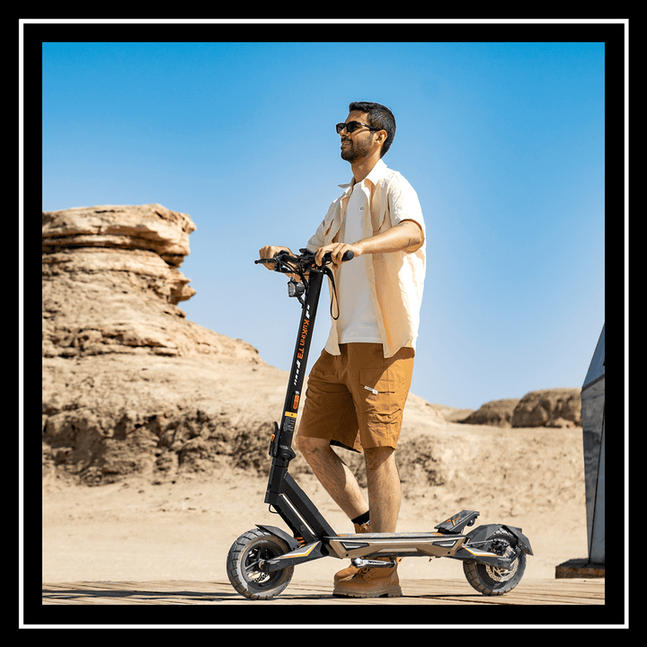 Person riding the kukirin electric scooter t3 in a desert landscape under a clear blue sky.