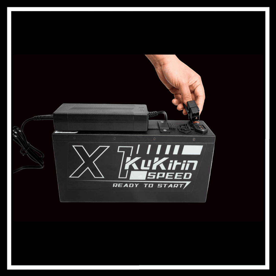 KUKIRIN X1 ELECTRIC DIRT BIKE battery charging with hand connecting charger.