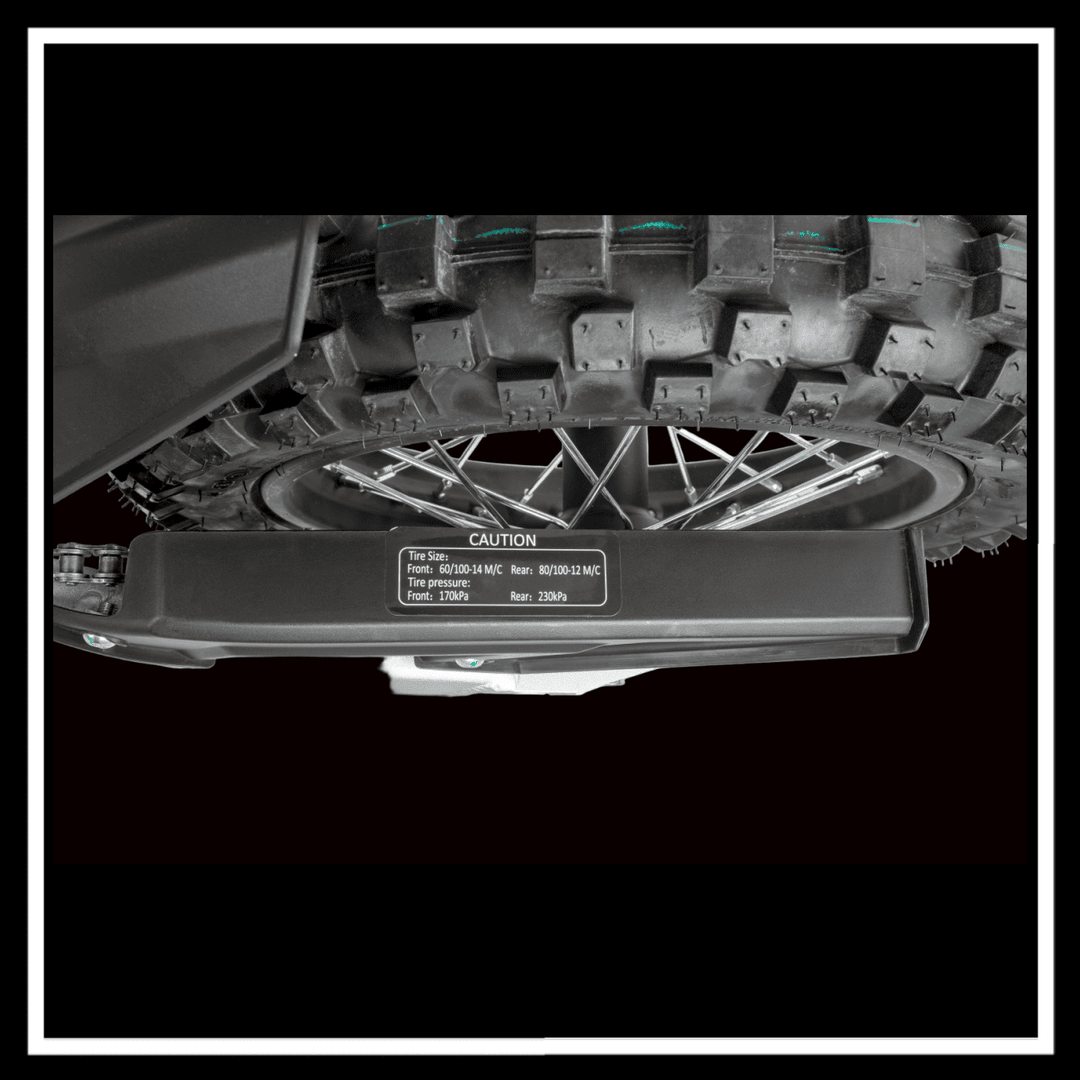 KUKIRIN X1 ELECTRIC DIRT BIKE tire close-up showing tread pattern and caution label for performance specifications.