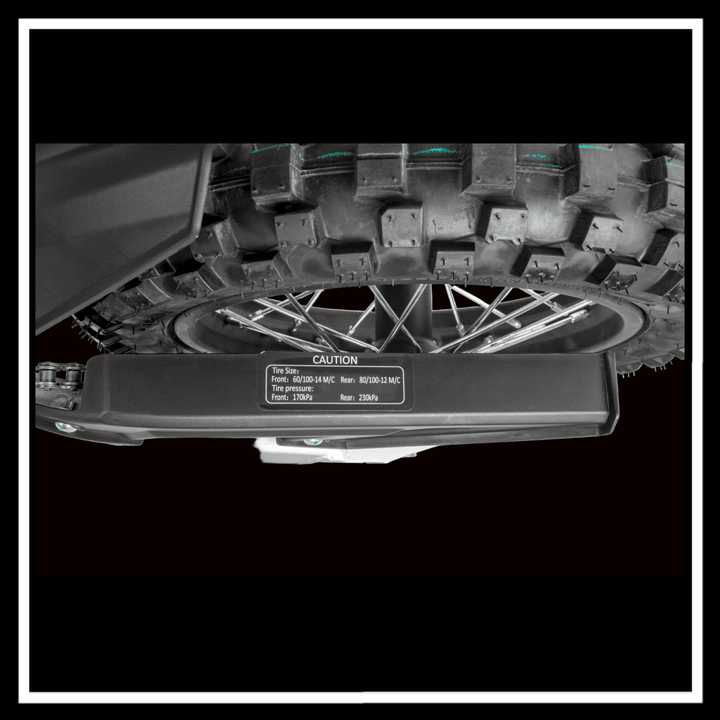 KUKIRIN X1 ELECTRIC DIRT BIKE tire close-up showing tread pattern and caution label for performance specifications.