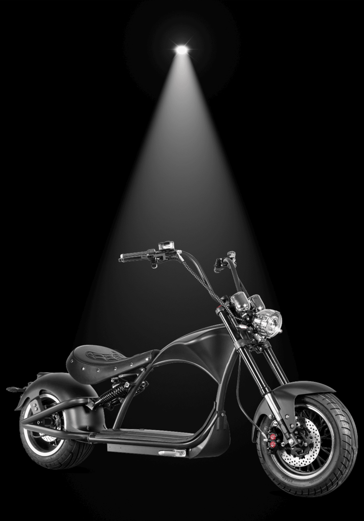 M1P electric chopper motorcycle showcased in spotlight, highlighting its sleek design and Harley-style features.