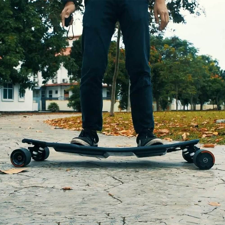 Person riding the 🇮🇪🇪🇺🇺🇸 MAXFIND FF PRO electric skateboard in a park setting.