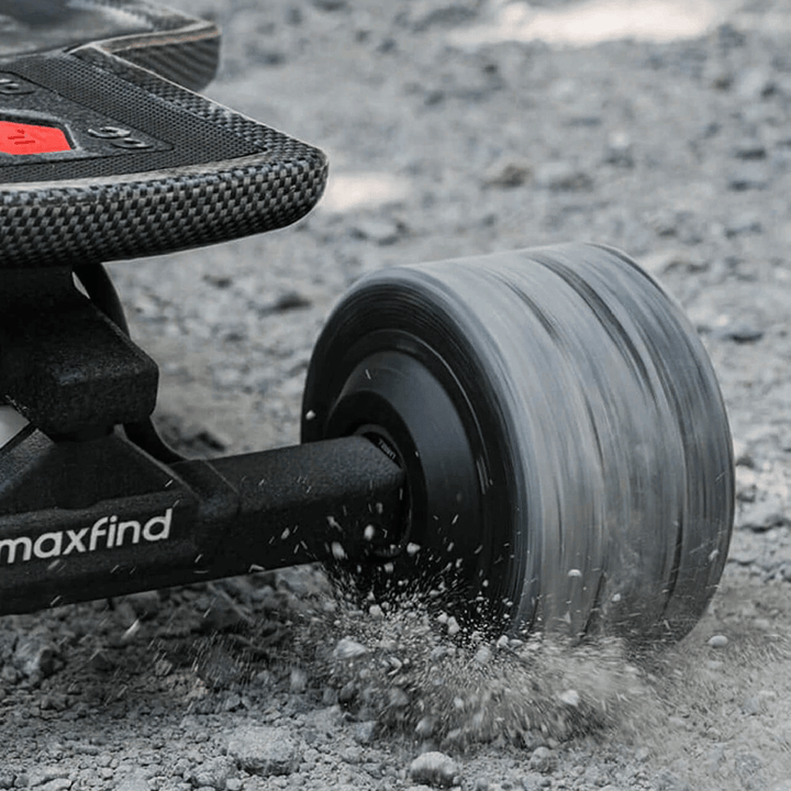 Maxfind FF Pro electric skateboard wheel on rough terrain, showcasing dual motors and shock-absorbing capabilities.