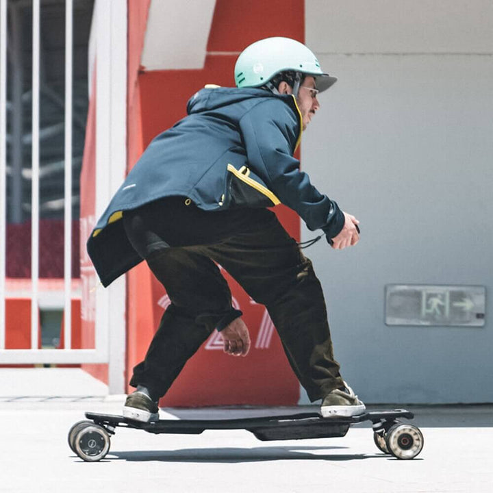 A person riding the 🇮🇪🇪🇺🇺🇸 MAXFIND FF PRO electric skateboard, showcasing its speed and performance.