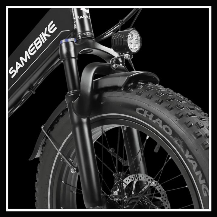 Close-up of the SAMEBIKE LOTDM200 II front fork and tire with a headlight for enhanced urban commuting.