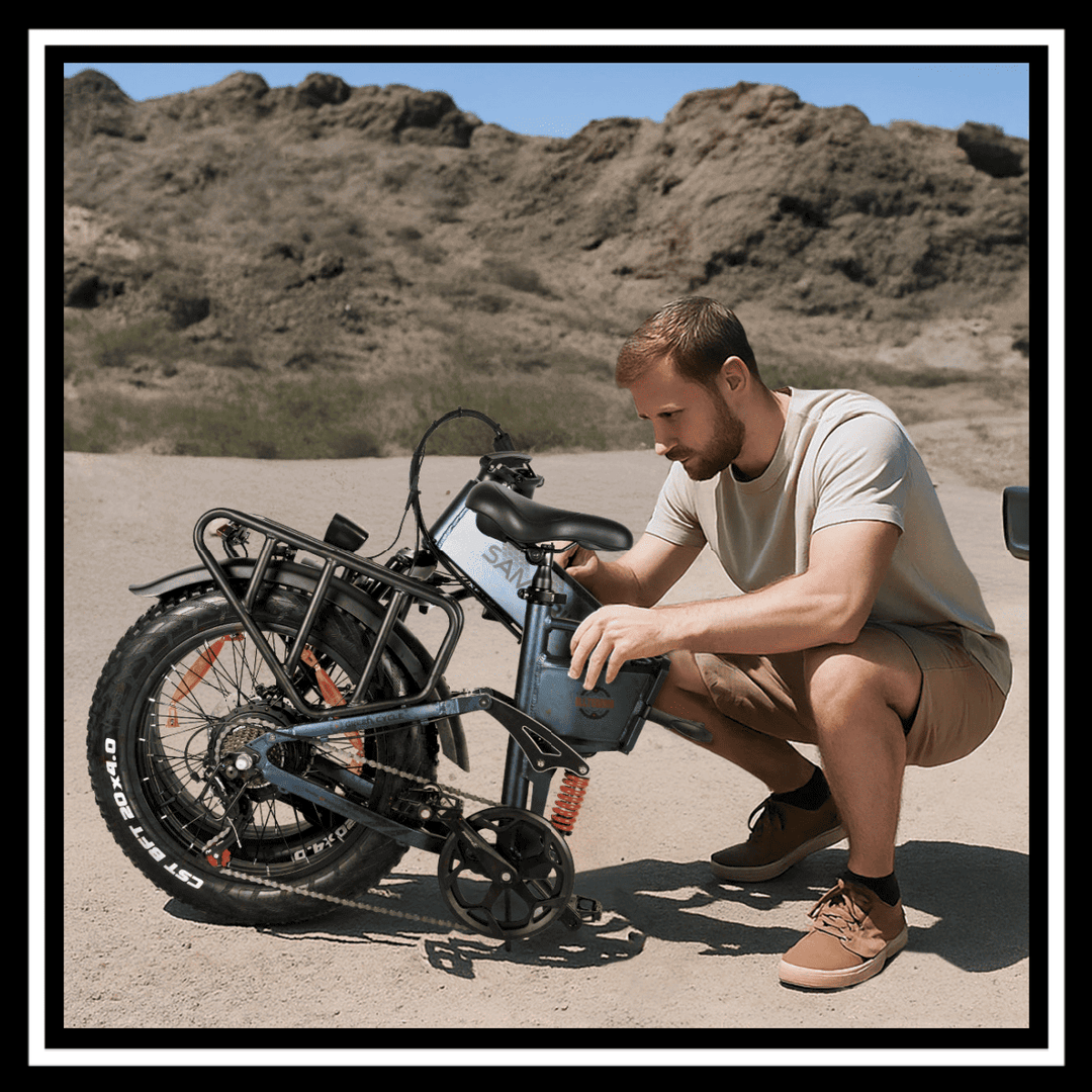 A rider adjusting the battery on a SAMEBIKE RS-A02 PRO fat tire off-road e-bike in a rugged terrain.