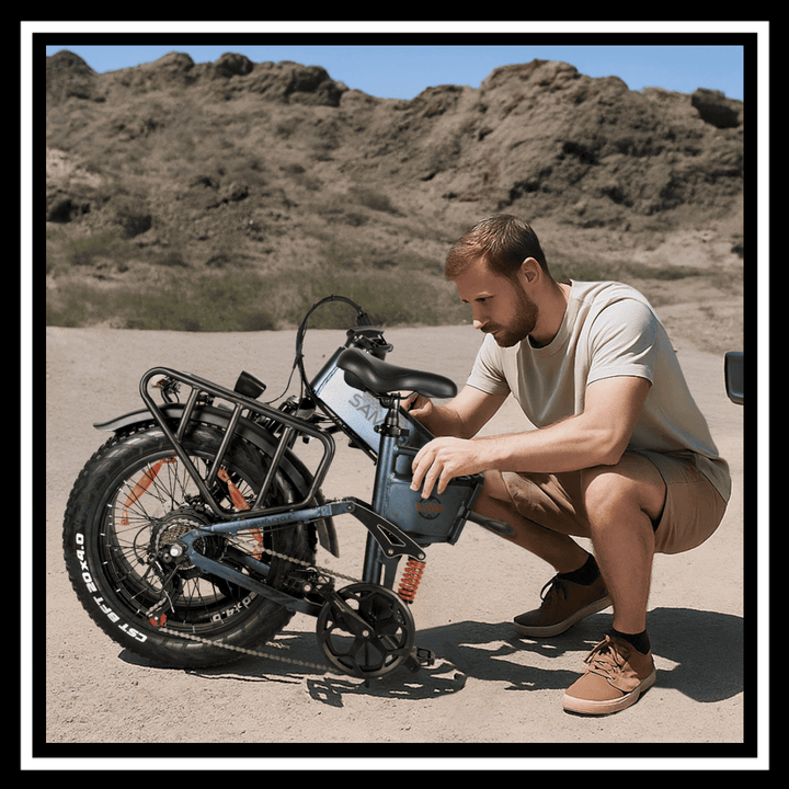 A rider adjusting the battery on a SAMEBIKE RS-A02 PRO fat tire off-road e-bike in a rugged terrain.
