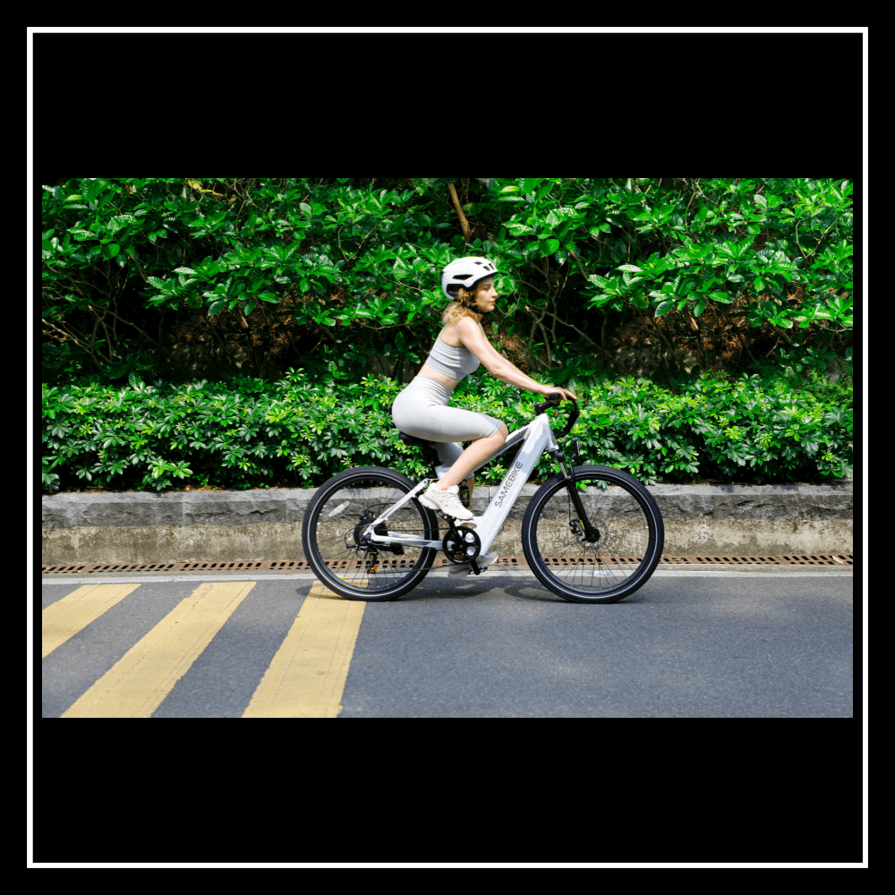 Woman riding the 🇮🇪🇪🇺🇺🇸🇬🇧 SAMEBIKE XD26-II electric bike on a bike-friendly road.