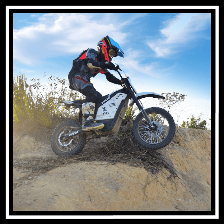 Rider navigating off-road with the VIPCOO H2 electric dirt bike in a rugged terrain.